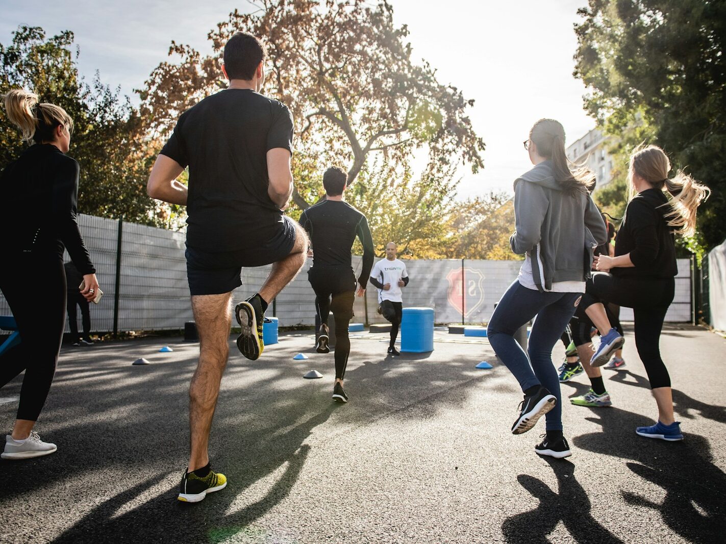 man in black t-shirt and black shorts running on road during daytime